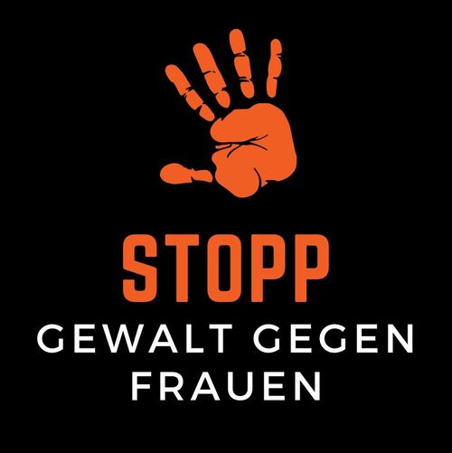 Schriftzug „Stopp Gewalt gegen Frauen" in Orange auf schwarzem Grund